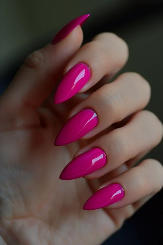 Hot pink almond-shaped nails with a glossy finish.
