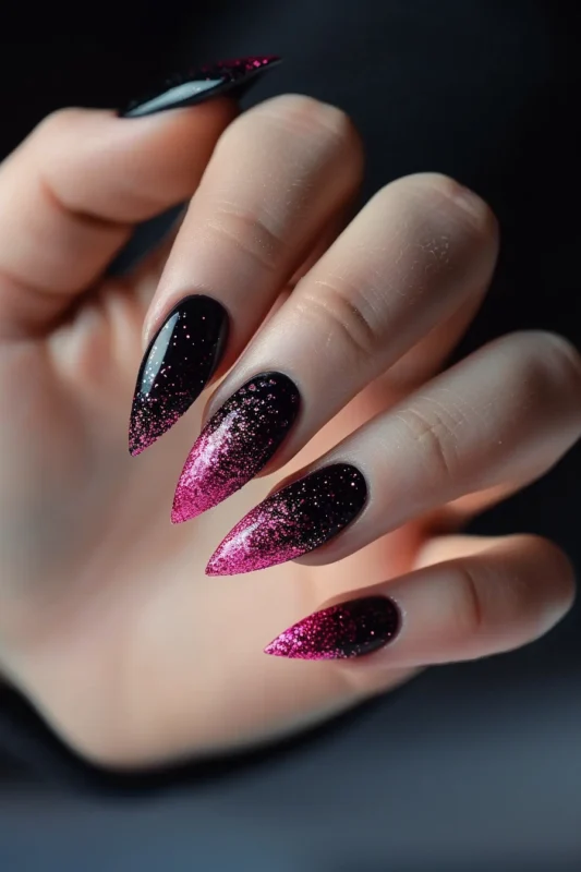 Stiletto nails with black to hot pink glitter gradient.