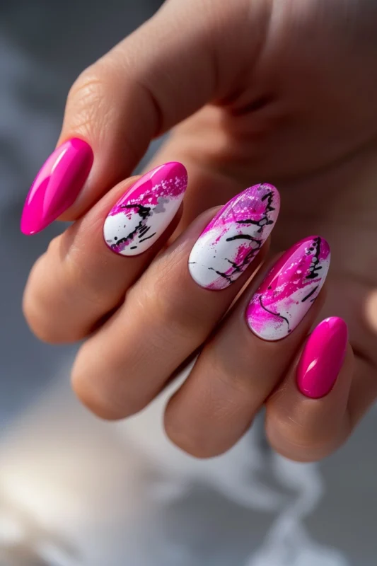 Oval nails with hot pink, white, and black graffiti design.