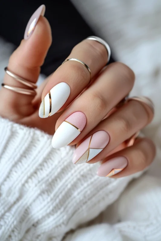 Almond-shaped nails with pink, white, and gold stripes.