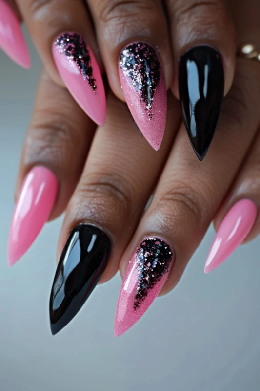 Stiletto nails with pink, black, and glitter design.