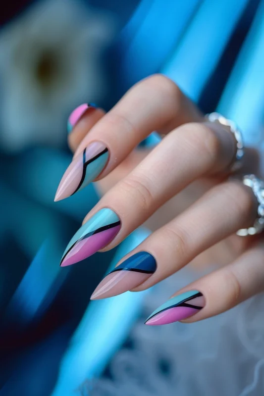 Stiletto nails with pink, blue, and nude geometric design.