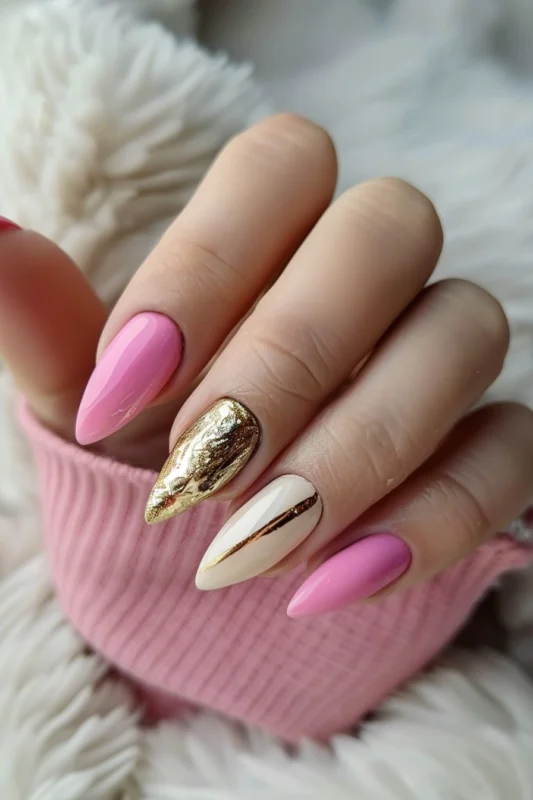 Pink nails with gold accents and foil.