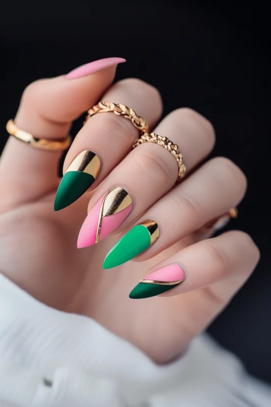 Pink and green nails with gold line accents.