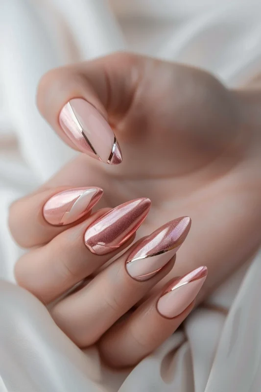 Almond-shaped nails with rose gold and pink design.