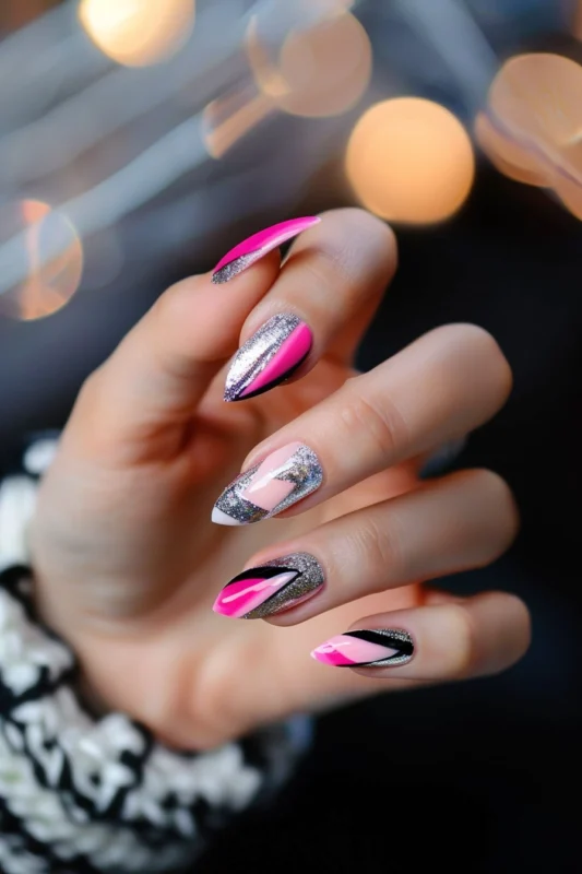 Pointy-tip nails featuring pink and silver glitter.