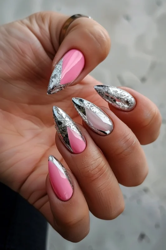 Stiletto nails with pink and metallic silver accents.