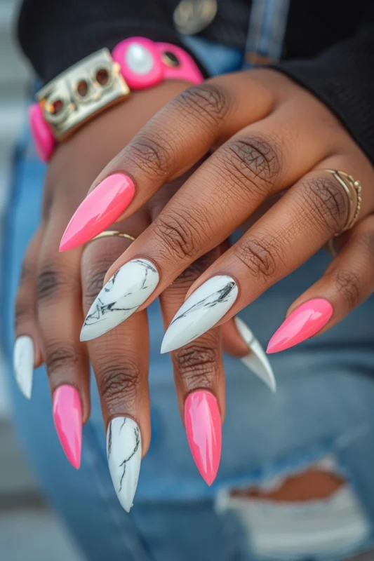 Stiletto nails with white marble and hot pink.