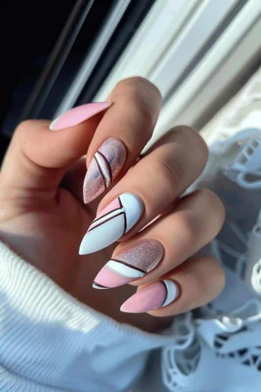 Stiletto nails with pink base and creative white tips.