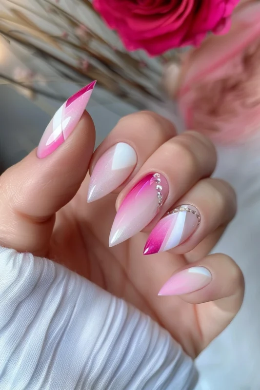 Almond-shaped nails with pink and white ombre and glitter overlay.