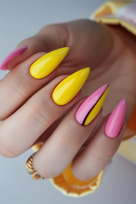 Stiletto nails in yellow and pink with an accent nail.
