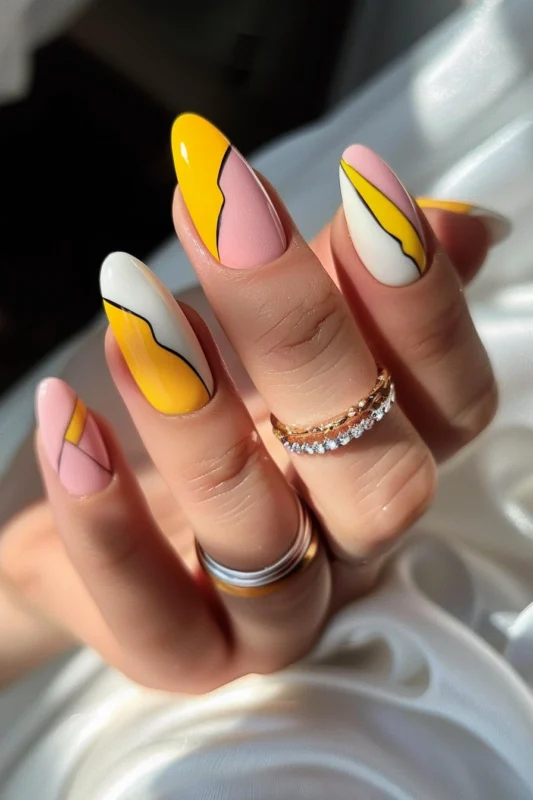 Matte nails with yellow and pink wave designs.