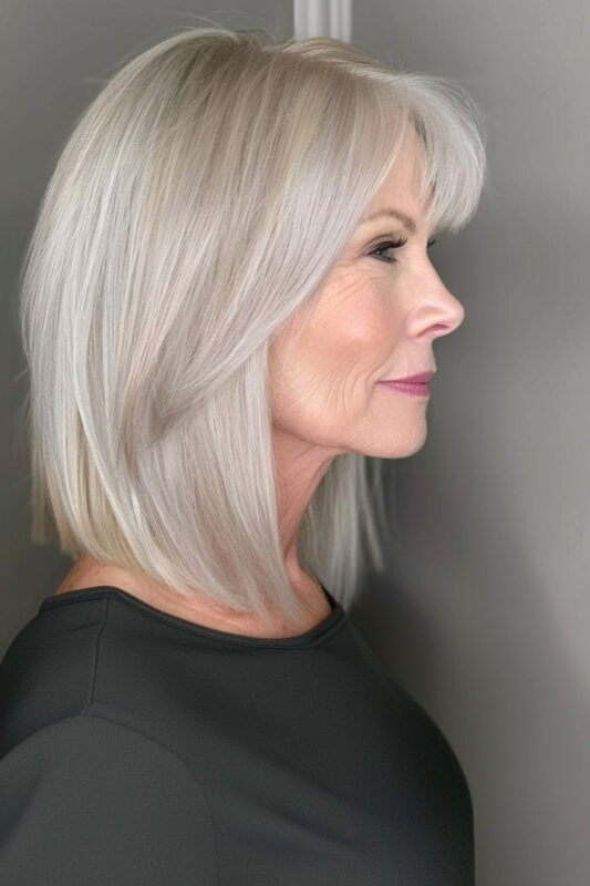 Picture of an older woman with a sleek long bob haircut with side bangs.