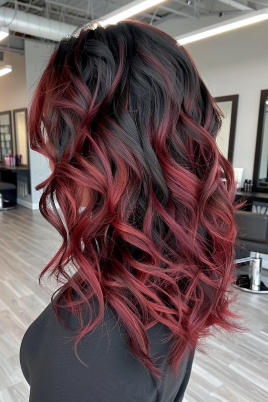 Black hair with deep red ombre transition.