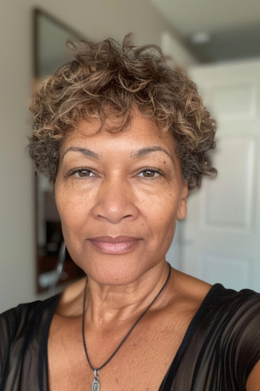 Picture of an older woman with a curly crop haircut.