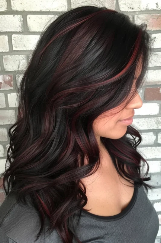 Black hair with subtle maroon red highlights.