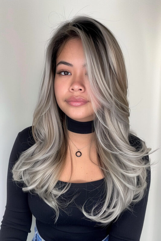 Woman with a black and silver butterfly cut straight hair.