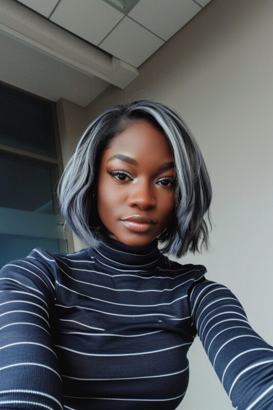 Woman with a short black and silver bob with tousled waves.