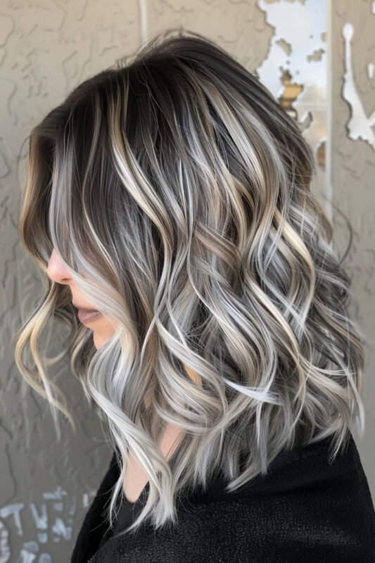 Medium-length hair with light brown, blonde, and silver highlights in waves.