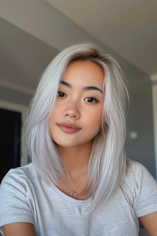 Woman with a sleek silver lob haircut