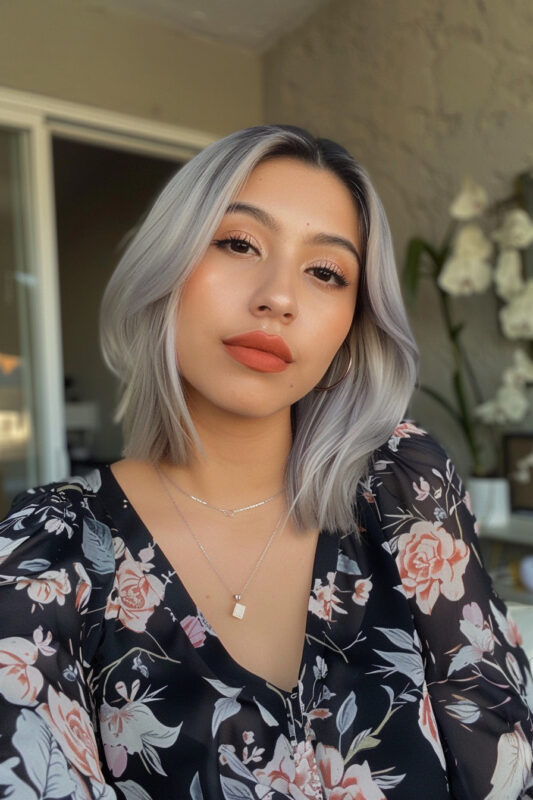 Woman with a short layered silver bob.