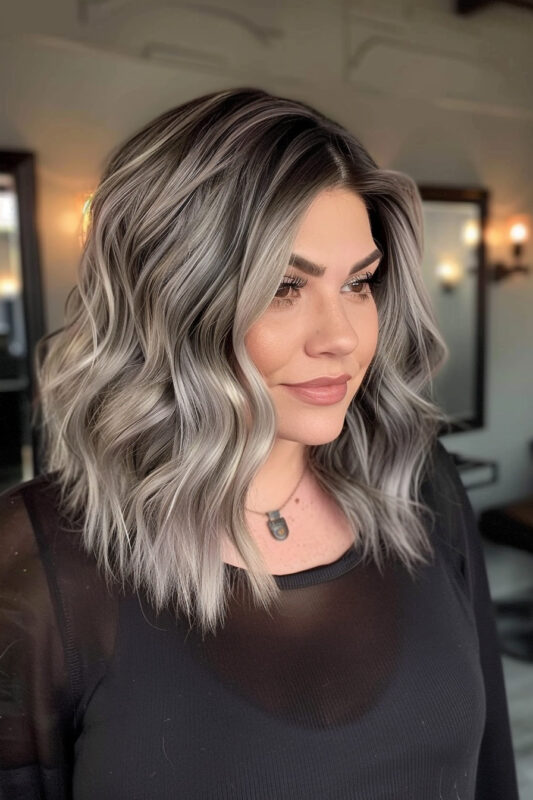 Woman with wavy brown hair featuring silver balayage highlights.