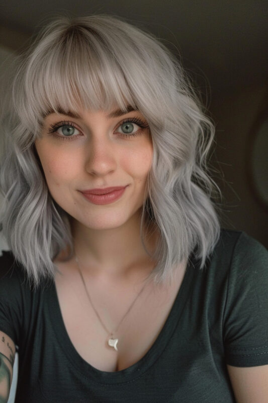 Woman with silver hair and straight-across bangs.