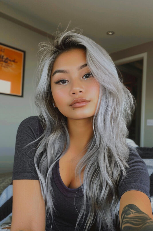 Woman with long silver hair and beautiful shadow root.