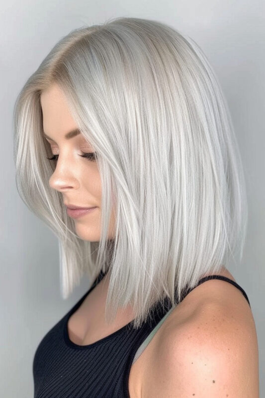 Woman with straight silver long bob haircut