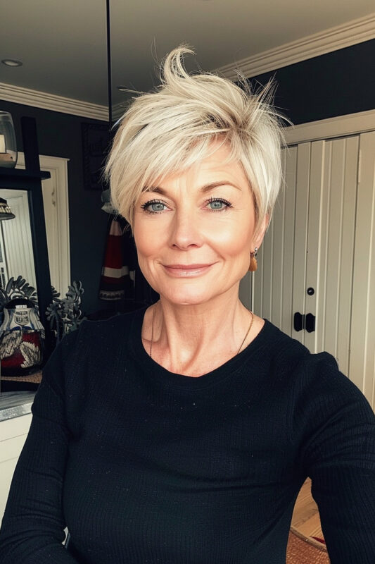 Woman with a long, blonde pixie cut.