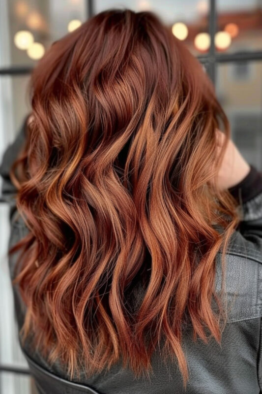 Woman with auburn hair and copper and blonde highlights.