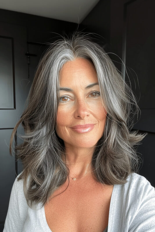 Woman with brunette hair going grey.