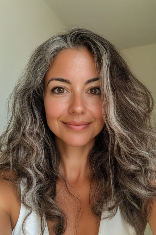 Woman with dark brown hair going grey.