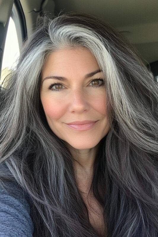 Woman transitioning from dark to grey hair.