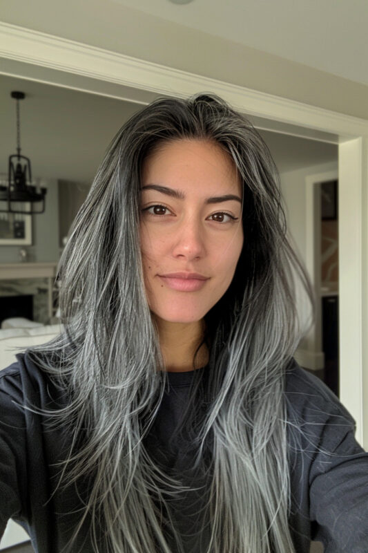 Woman going grey with dark hair.