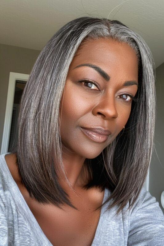 Woman growing out colored hair to grey.