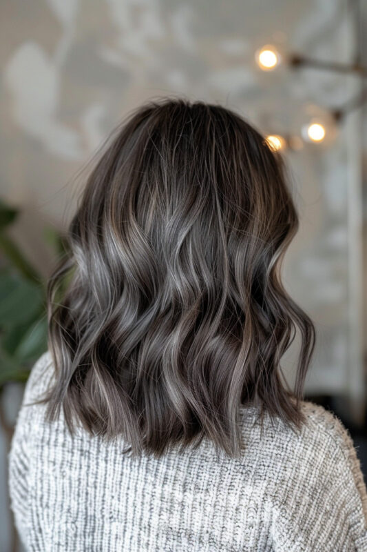 Woman with ash brown hair and ash blonde highlights.