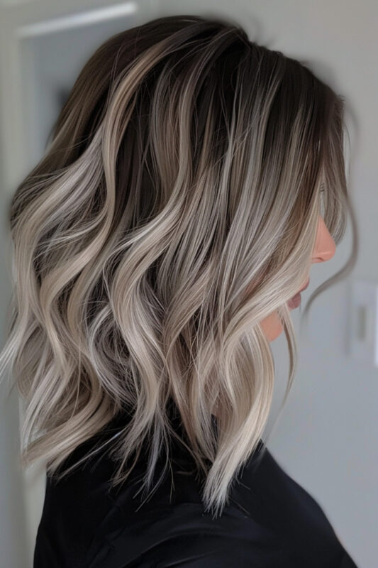 Woman with black and ash-toned hair.