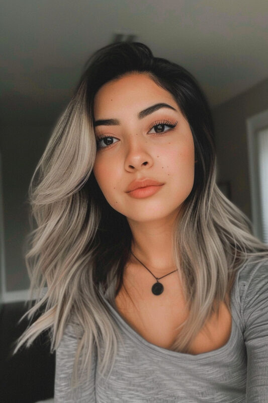 Woman with black to silver ombre hair.