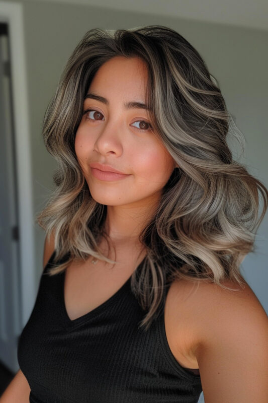 Woman with dark brown hair and an ash blonde balayage.