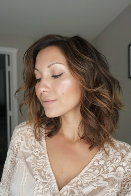 Woman with medium brown hair and caramel highlights.