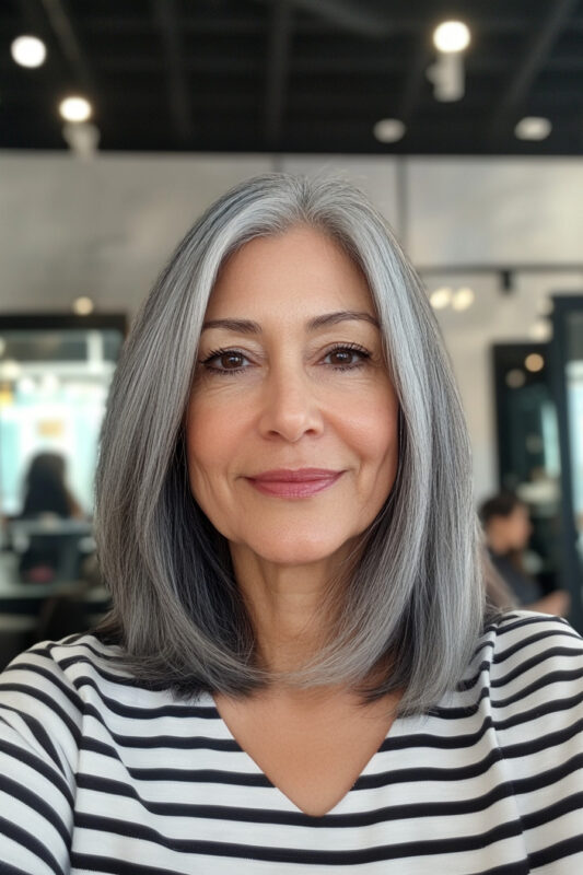 Woman over 50 with a long salt and pepper bob.