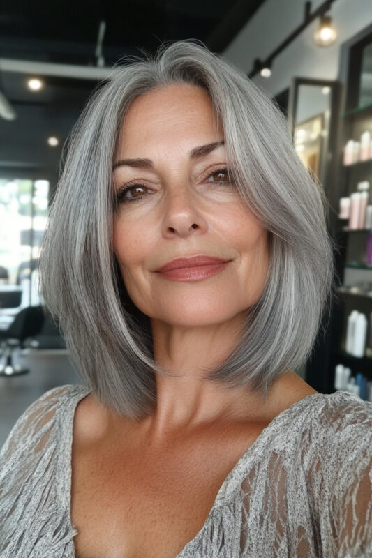 Woman over 50 with a long textured salt and pepper bob.