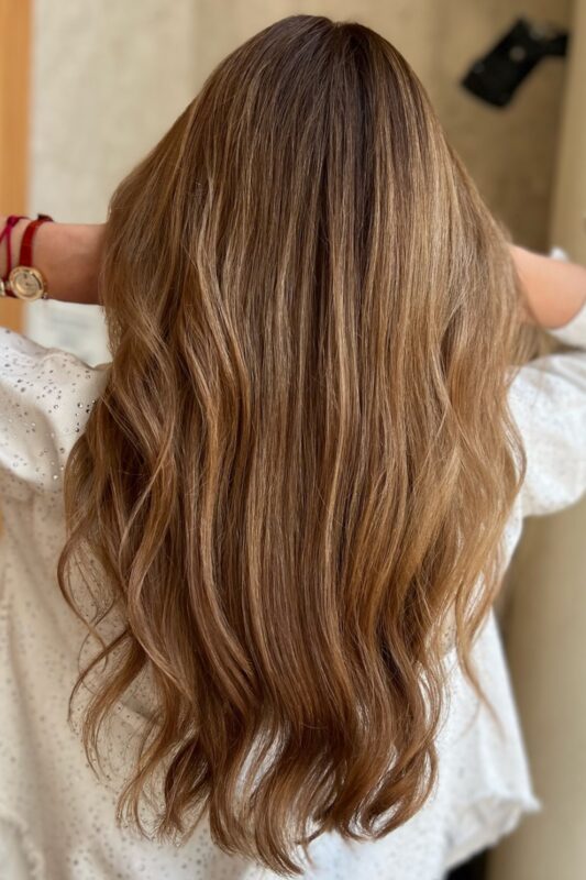 A woman with a soft beige brown hair color.