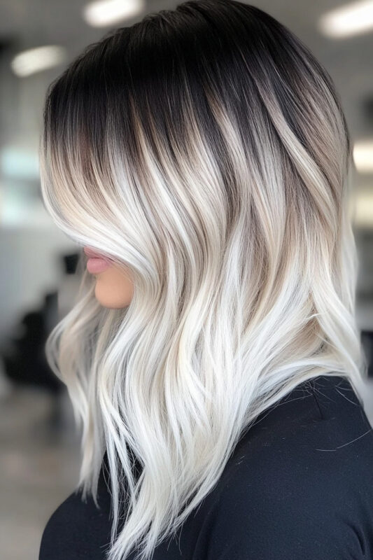 Woman with a platinum ombre on a black base.