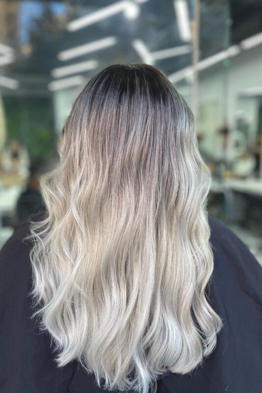 Woman with a platinum ombre on a black base.