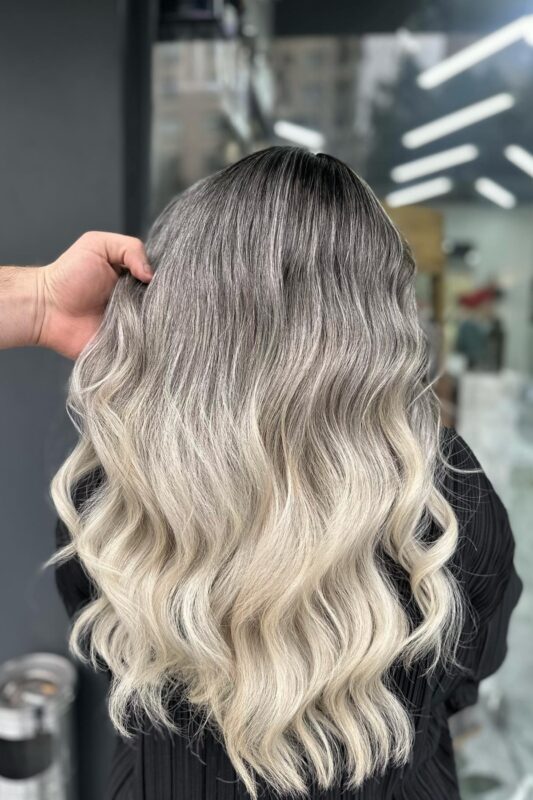 Woman with black hair and a champagne blonde ombre.