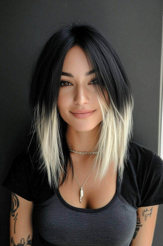 Woman with black hair and a blonde dip dye.