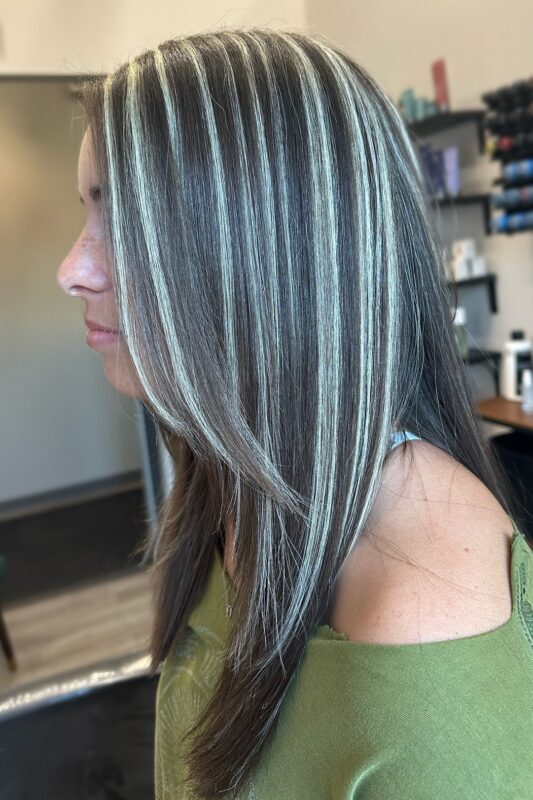 Woman with jet black hair and full platinum highlights.