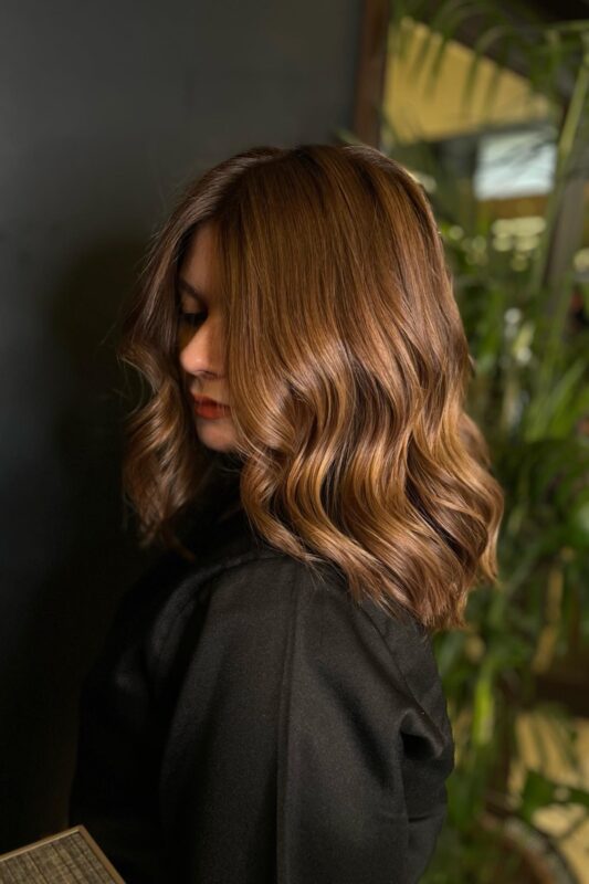 A woman with a bronde hair color.